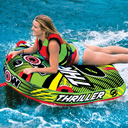 Woman on a colorful 'Thriller' water tube in the water