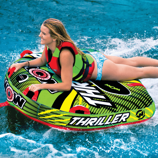 Woman on a colorful 'Thriller' water tube in the water