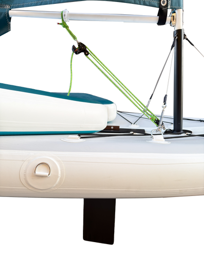 Close-up of a sailboat with a green sail and white hull.