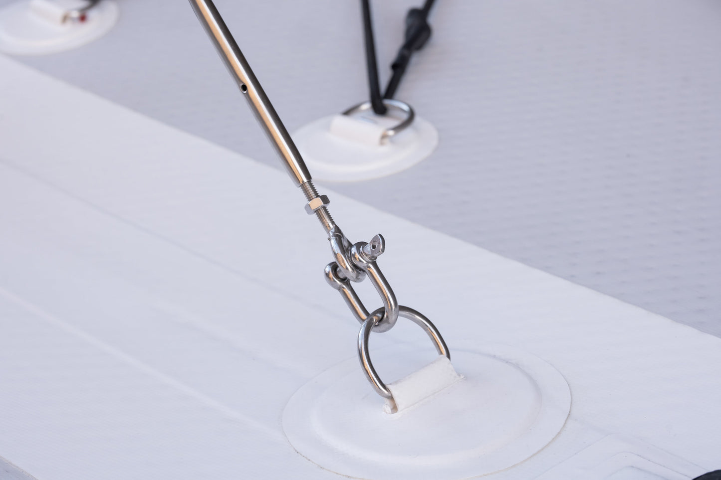 Metallic tool with a white object on a light gray background