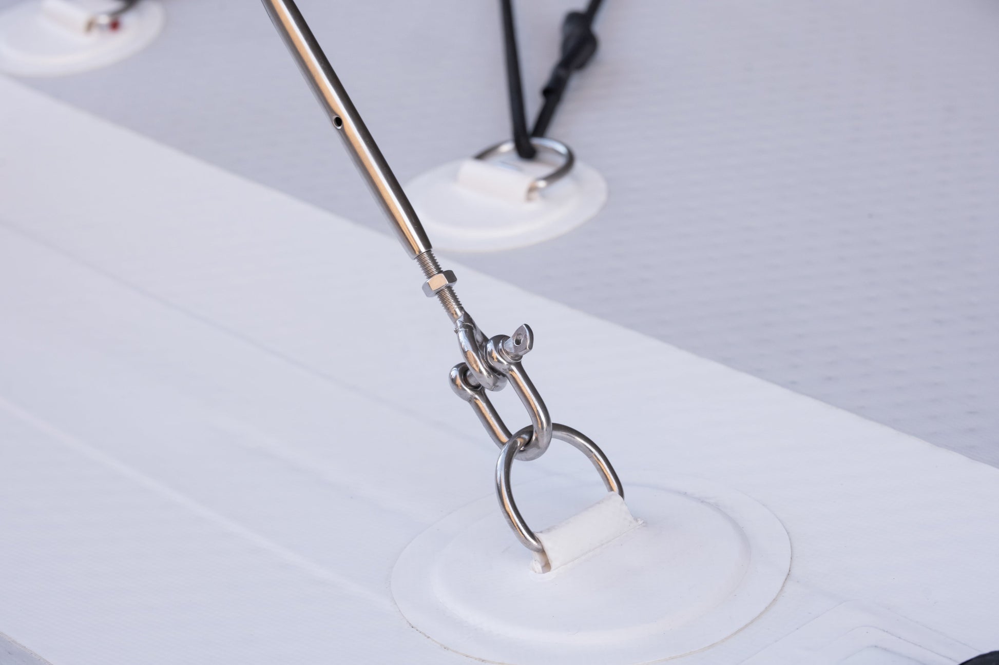 Metallic tool with a white object on a light gray background