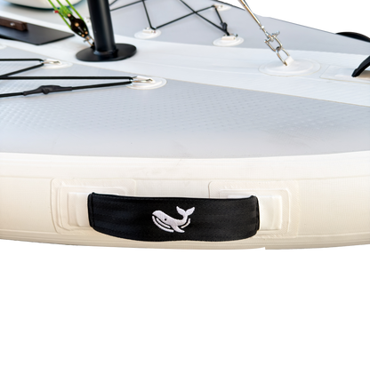 Close-up of a kayak with a black strap featuring a whale design on a white background
