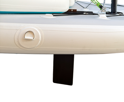 Close-up of a boat's white hull with a black fin on a white background