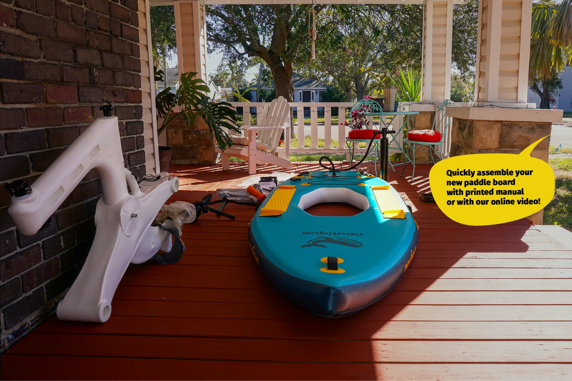 Blue paddle board with accessories on a wooden deck, with text about assembly instructions.