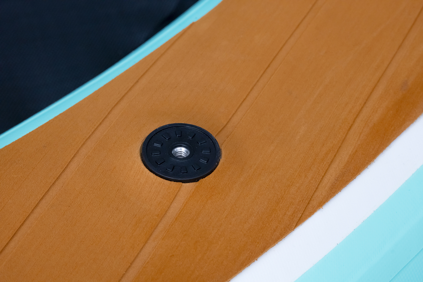 Close-up of a wooden surface with a black circular object on it