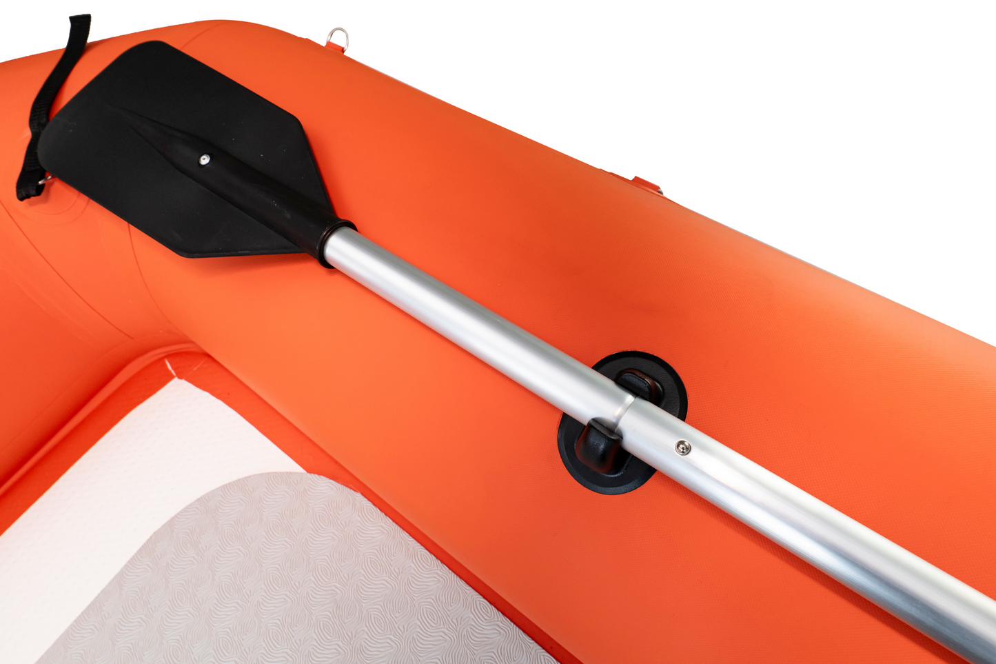 Paddle attached to an orange inflatable boat on a white background