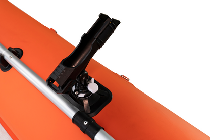 Close-up of a kayak with a paddle holder on an orange kayak against a white background