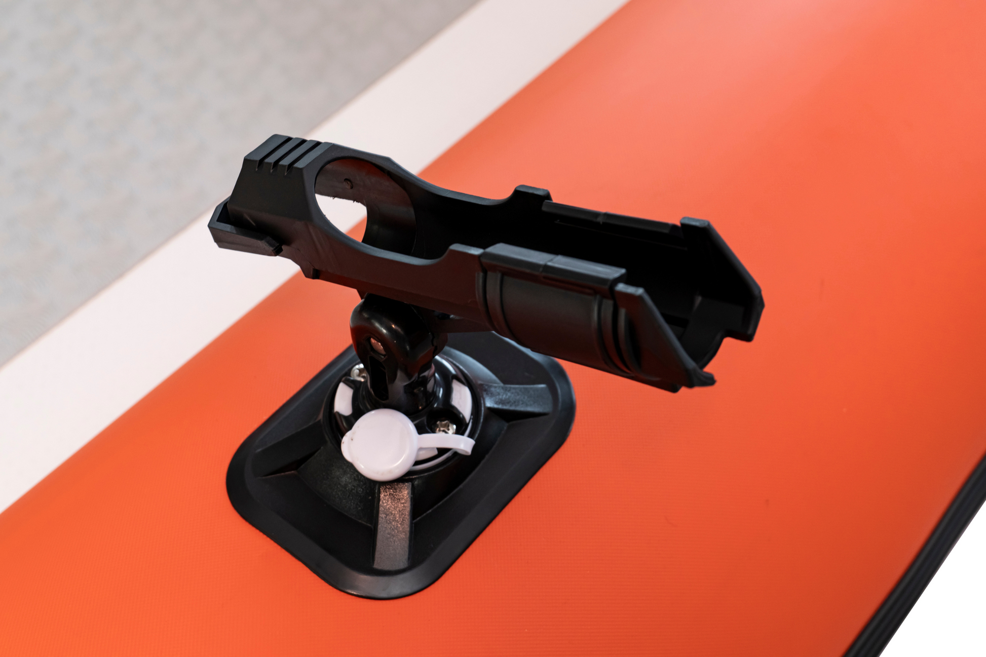 Black suction cup mount on a red surface