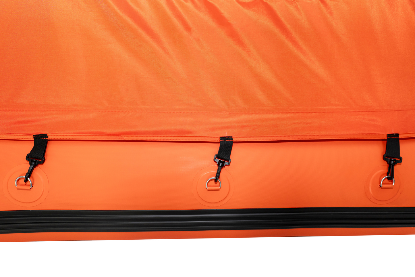 Close-up of an orange bag with black zippers and hardware on a white background