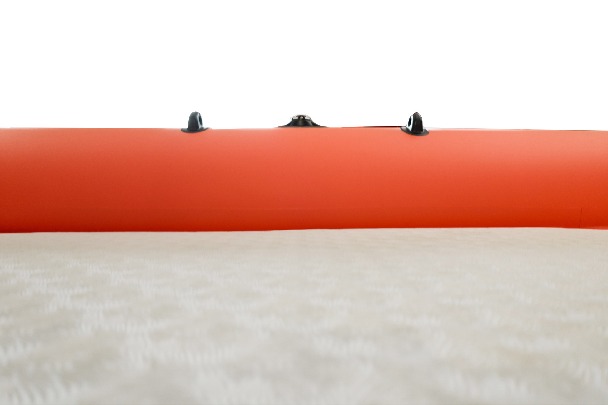 Close-up of an orange inflatable boat with black floor straps on a white background