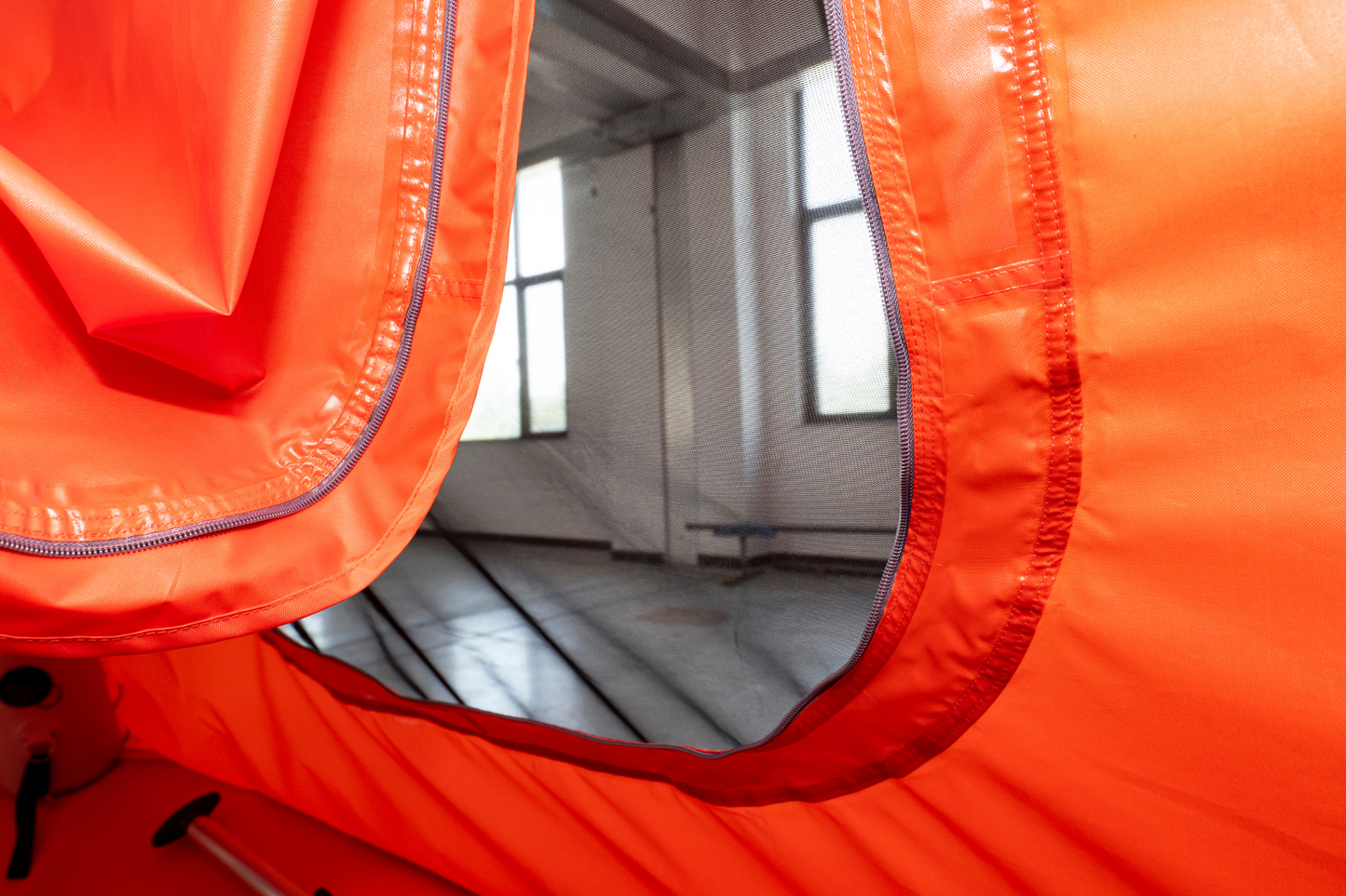 Close-up of an orange inflatable pool with a transparent section showing water inside.