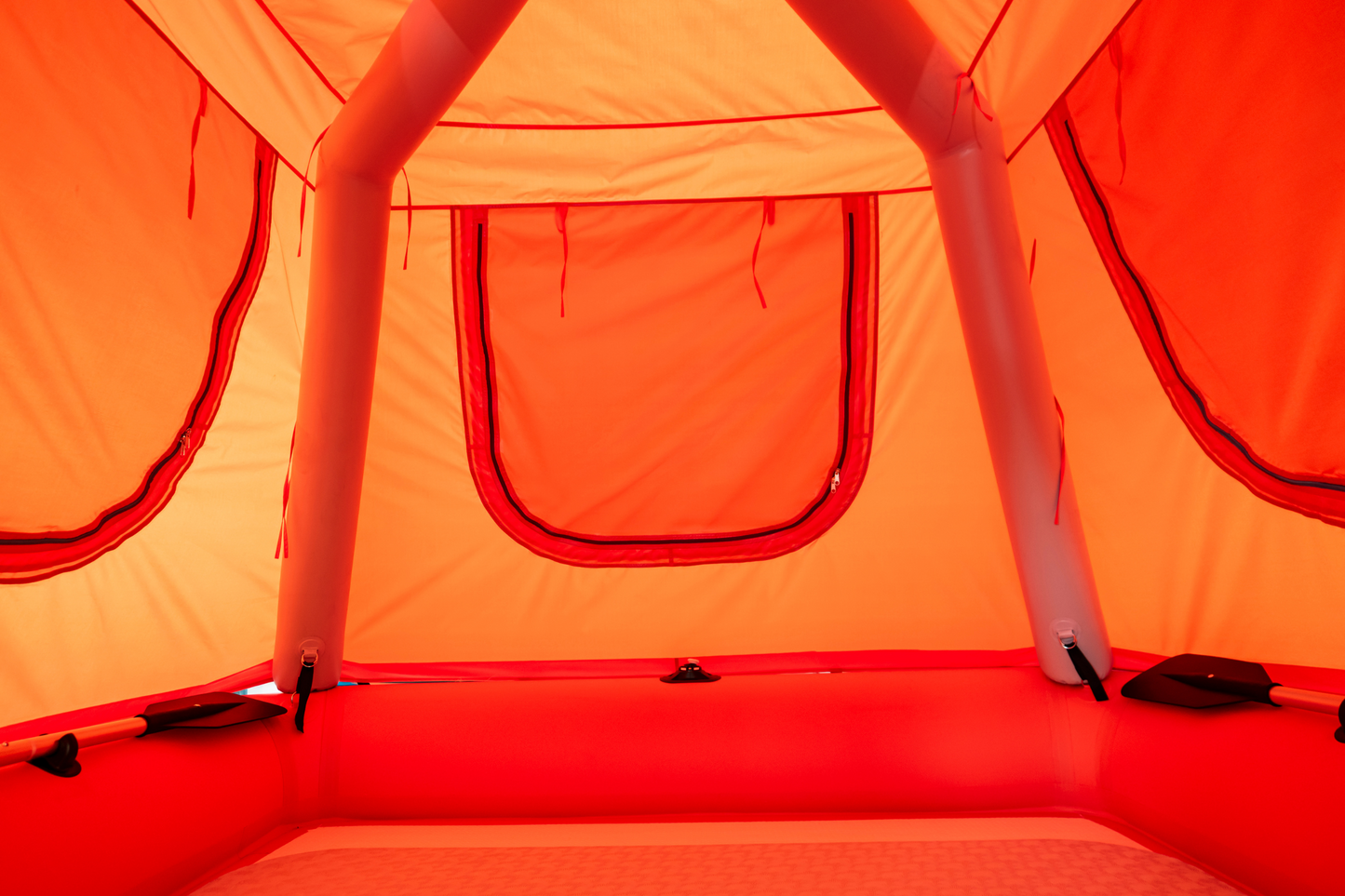 Orange inflatable tent interior with a window