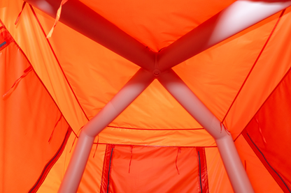 Close-up of an orange tent interior with a person's legs visible.