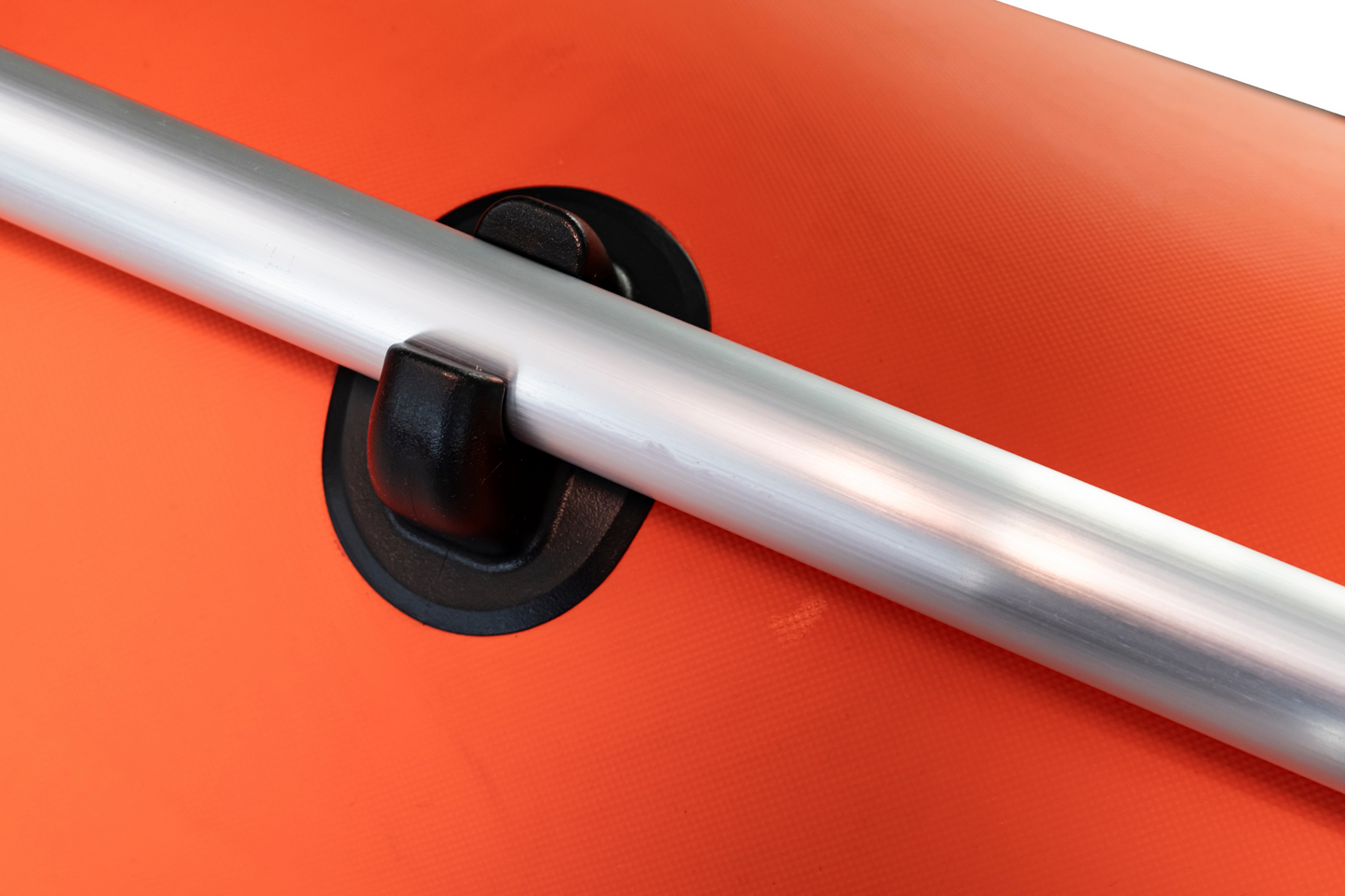 Close-up of a metal handle on an orange surface