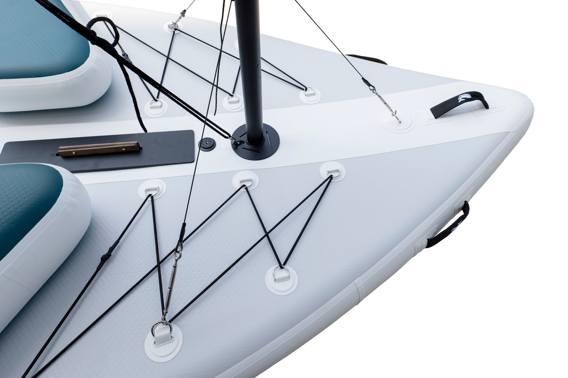 Close-up of a sailboat's bow with a white hull and black rigging.