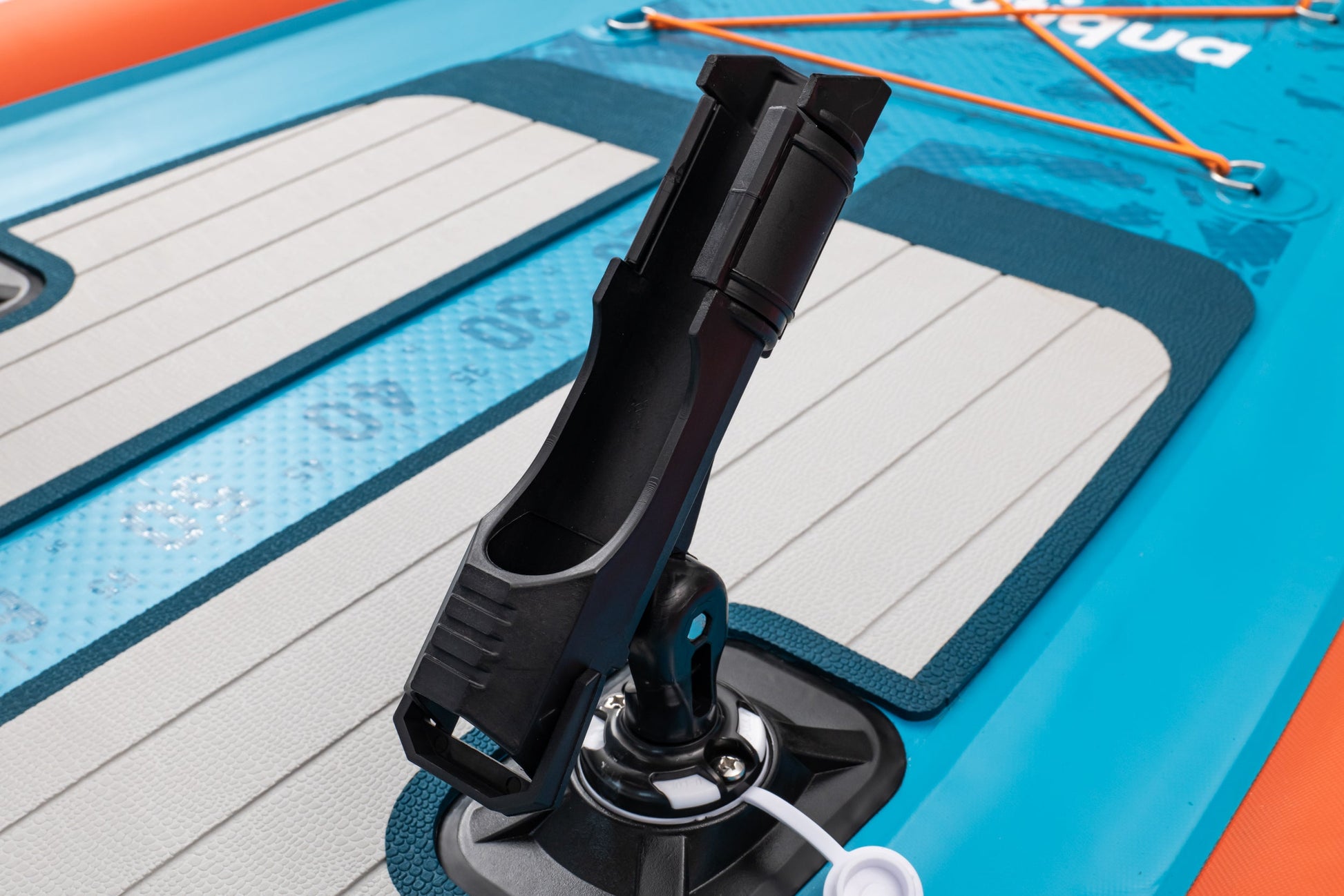 Close-up of a pump nozzle on an inflatable water board with 'Aqua' branding.