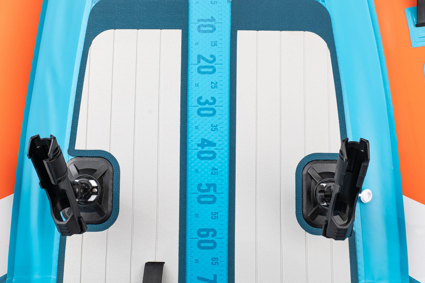 Close-up of a inflatable board with measurement scale and foot straps.
