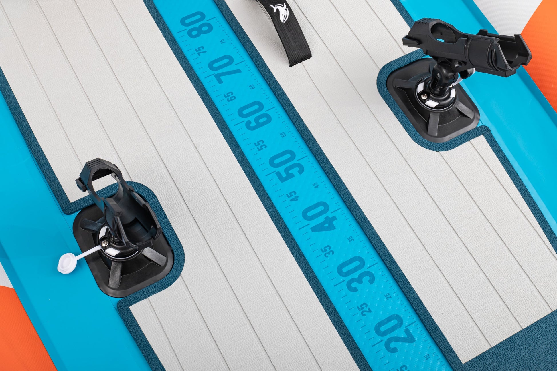 Close-up of a surfboard with measurement markings and black attachments on a white background