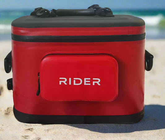 Red cooler box with 'RIDER' branding on a beach